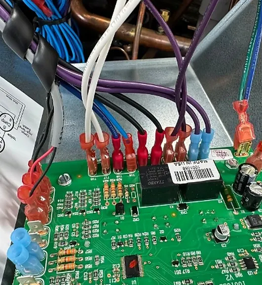 Interior of a pool automation control panel showing wiring and a circuit board